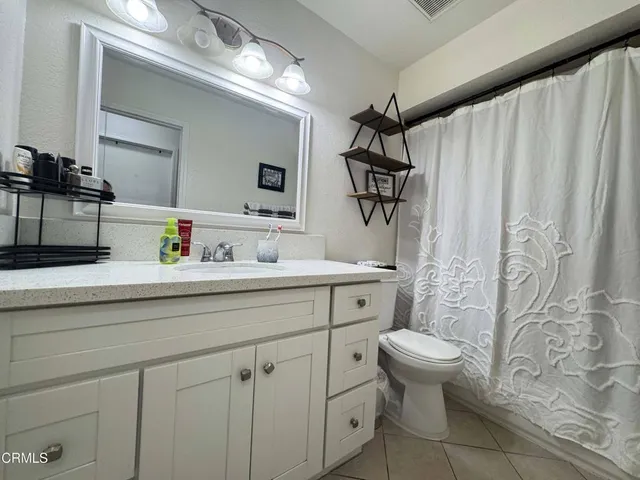 a bathroom with a sink toilet tub and shower