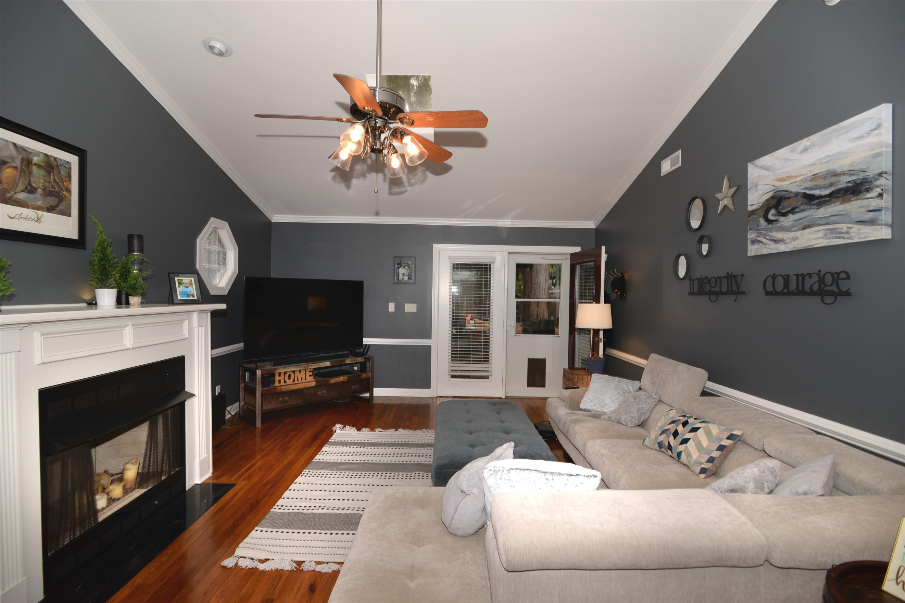 1023 Legend Road Raleigh, NC 27603 - Photo 10 of 30 This living room is expansive and elegant- high ceilings and hardwood floors, crown molding and chair railing. All this plus a beautiful focal fireplace! Living Room