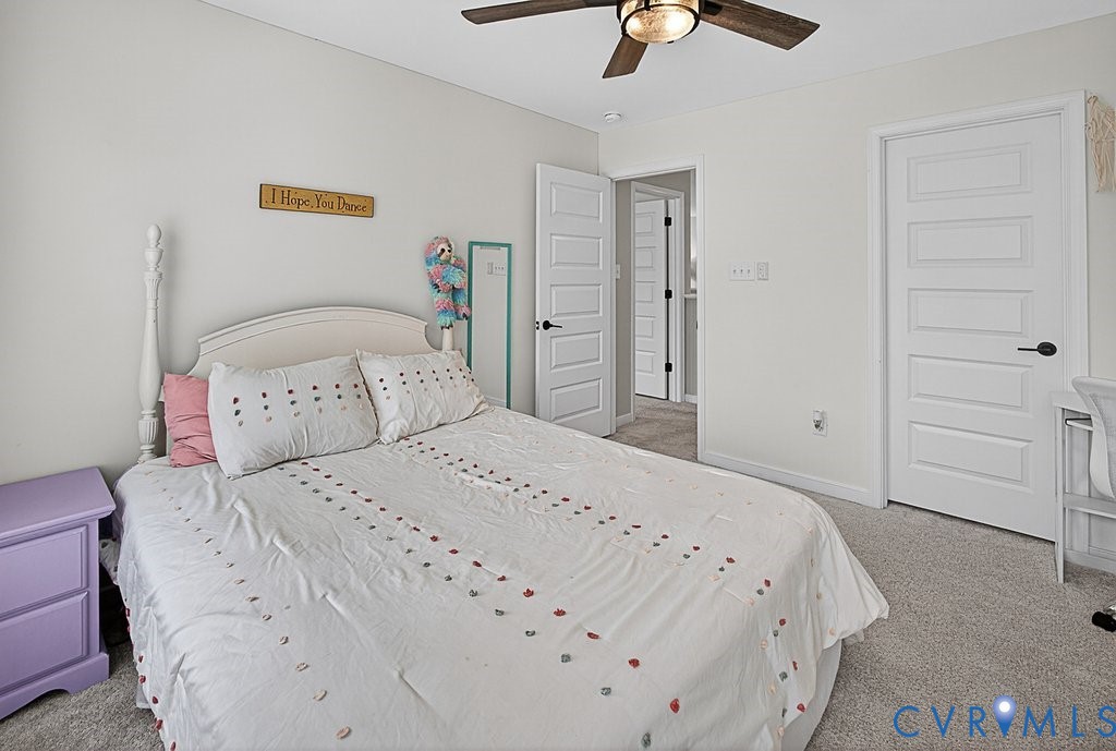 18517 Palisades Ridge Moseley, VA 23120 - Photo 28 of 55 a bedroom with a bed and a chandelier