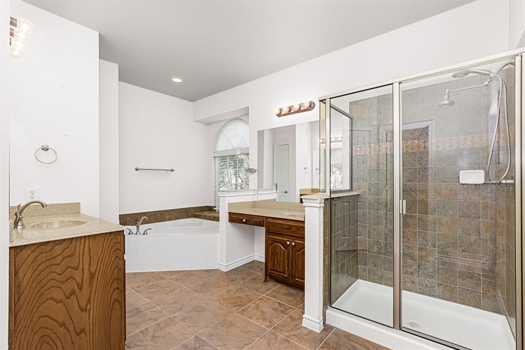 1325 Bateman Lane Celina, TX 75009 - Photo 17 of 39 a bathroom with a tub sink mirror and shower