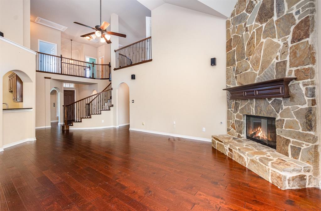 1325 Bateman Lane Celina, TX 75009 - Photo 3 of 39 a view of a livingroom with wooden floor and a fireplace