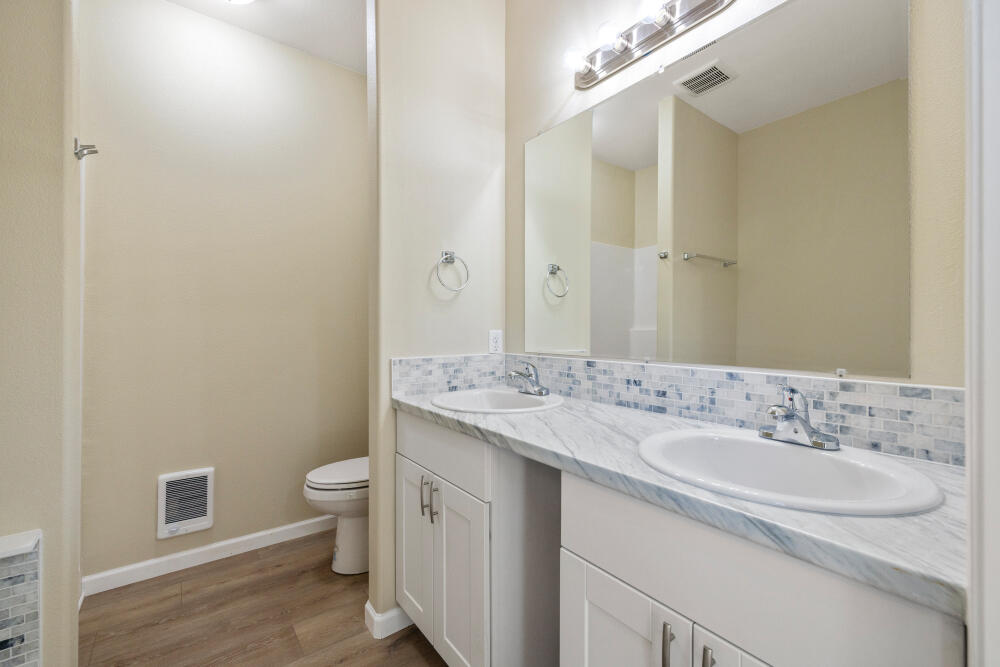 330 North Elm Street Merrill, OR 97633 - Photo 10 of 23 a bathroom with a granite countertop sink a toilet and a mirror