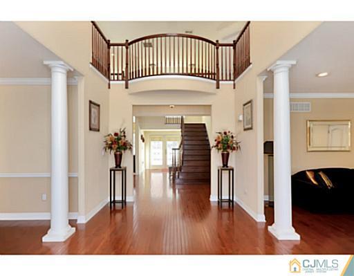4 Rustic Court Monroe Township, NJ 08831 - Photo 2 of 25 a view of a livingroom with wooden floor and staircase