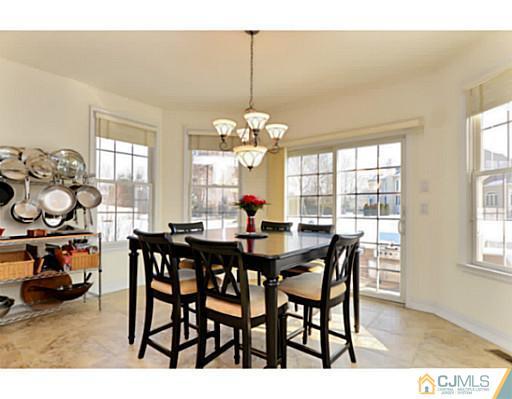 4 Rustic Court Monroe Township, NJ 08831 - Photo 11 of 25 a view of a dining room and livingroom with furniture wooden floor a chandelier