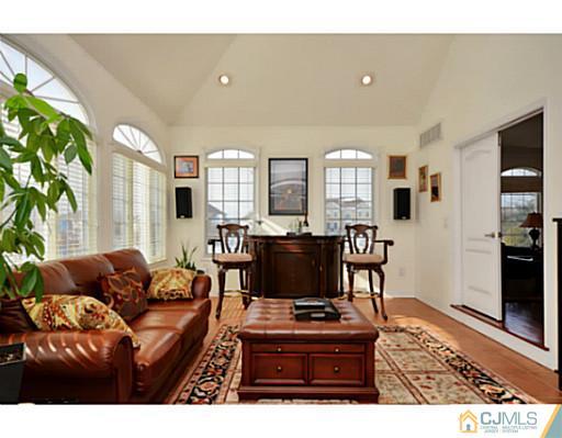 4 Rustic Court Monroe Township, NJ 08831 - Photo 12 of 25 a living room with furniture and a flat screen tv