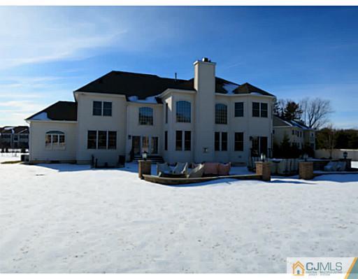 4 Rustic Court Monroe Township, NJ 08831 - Photo 25 of 25 a front view of a house with a yard covered in snow