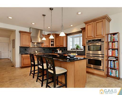 4 Rustic Court Monroe Township, NJ 08831 - Photo 7 of 25 a kitchen with kitchen island a counter top space appliances and a cabinets