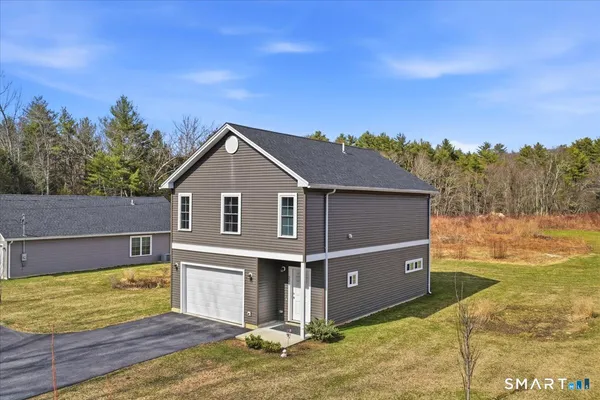 a view of a house with a backyard