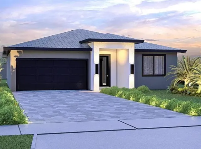 a front view of a house with a yard and garage