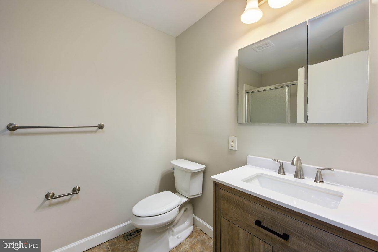 2004 Brierhill Road Fort Washington, MD 20744 - Photo 13 of 42 a bathroom with a granite countertop toilet sink and mirror