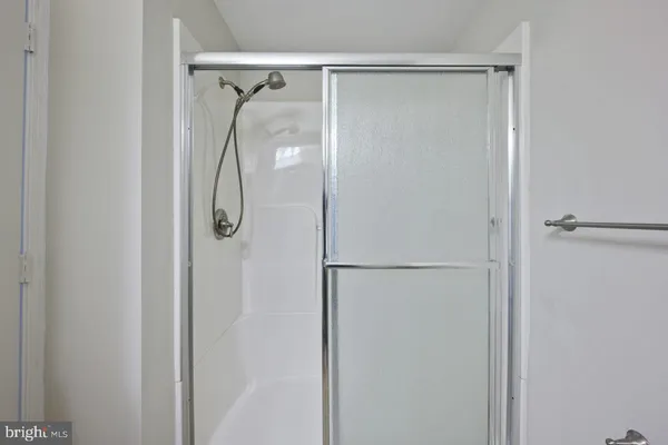 a bathroom with a glass shower door