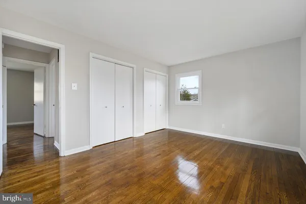 a view of an empty room and wooden floor