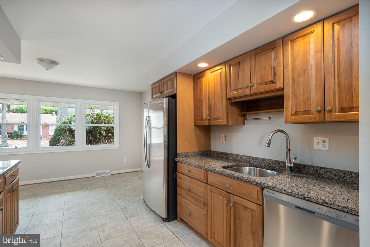 2004 Brierhill Road Fort Washington, MD 20744 - Photo 32 of 42 a kitchen with granite countertop a sink and a window