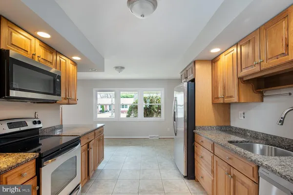 a kitchen that has a sink and a stove in it