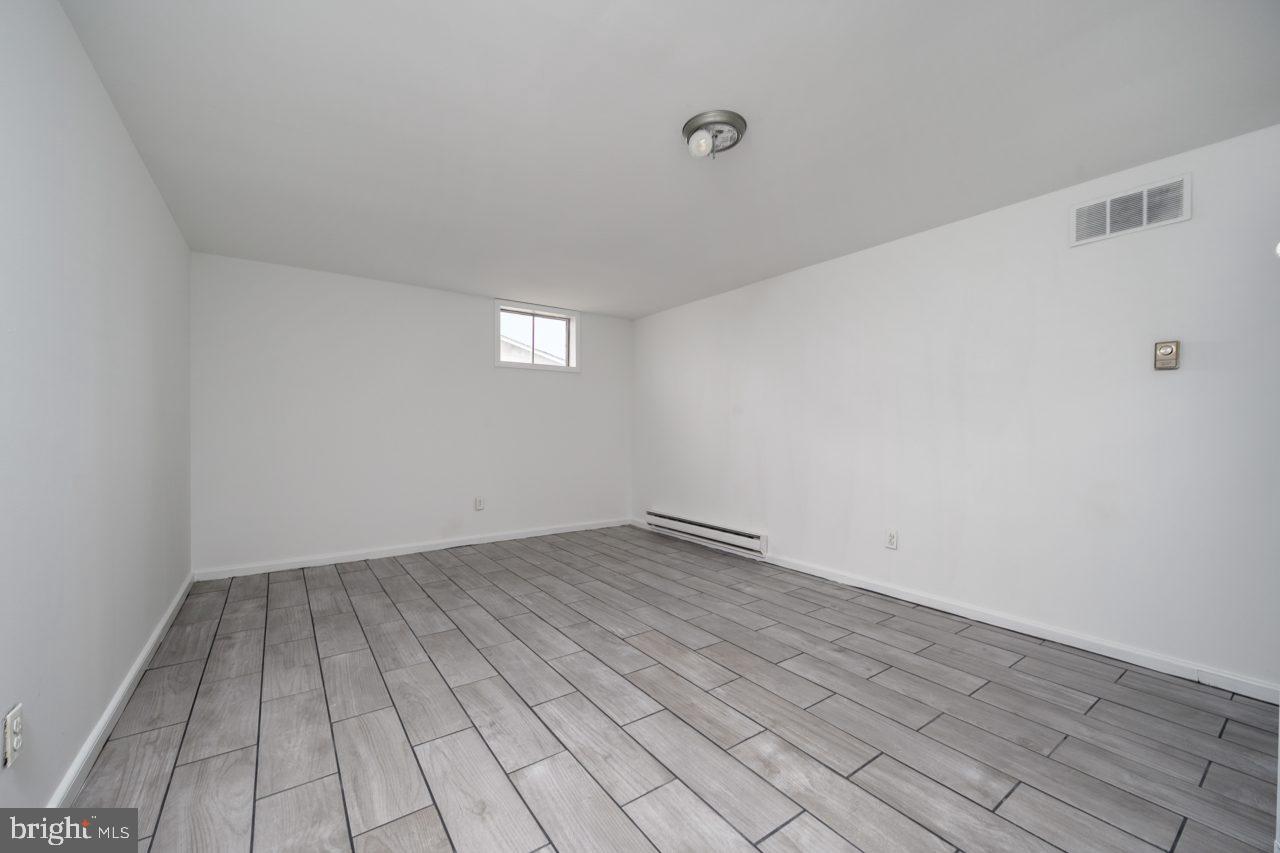 2004 Brierhill Road Fort Washington, MD 20744 - Photo 37 of 42 a view of an empty room with wooden floor and a window