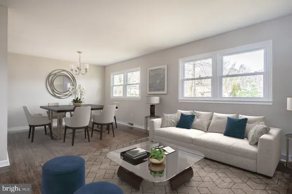 a living room with furniture a rug and a window