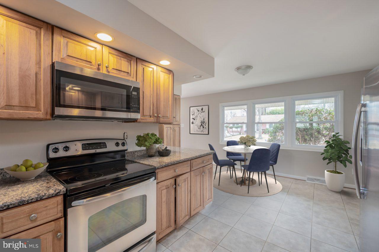 2004 Brierhill Road Fort Washington, MD 20744 - Photo 6 of 42 a kitchen with a stove cabinets and dining table