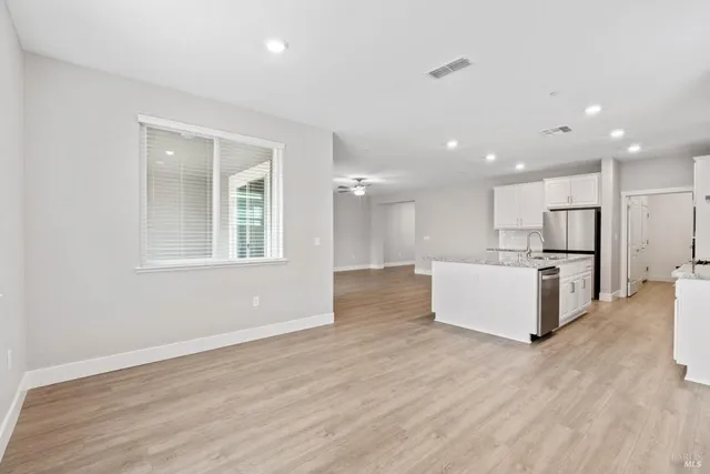 a view of kitchen with stainless steel appliances refrigerator oven and cabinets