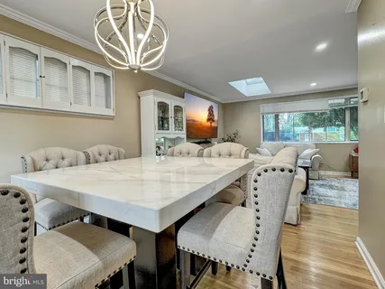 a large kitchen with stainless steel appliances granite countertop a sink a stove and a cabinets