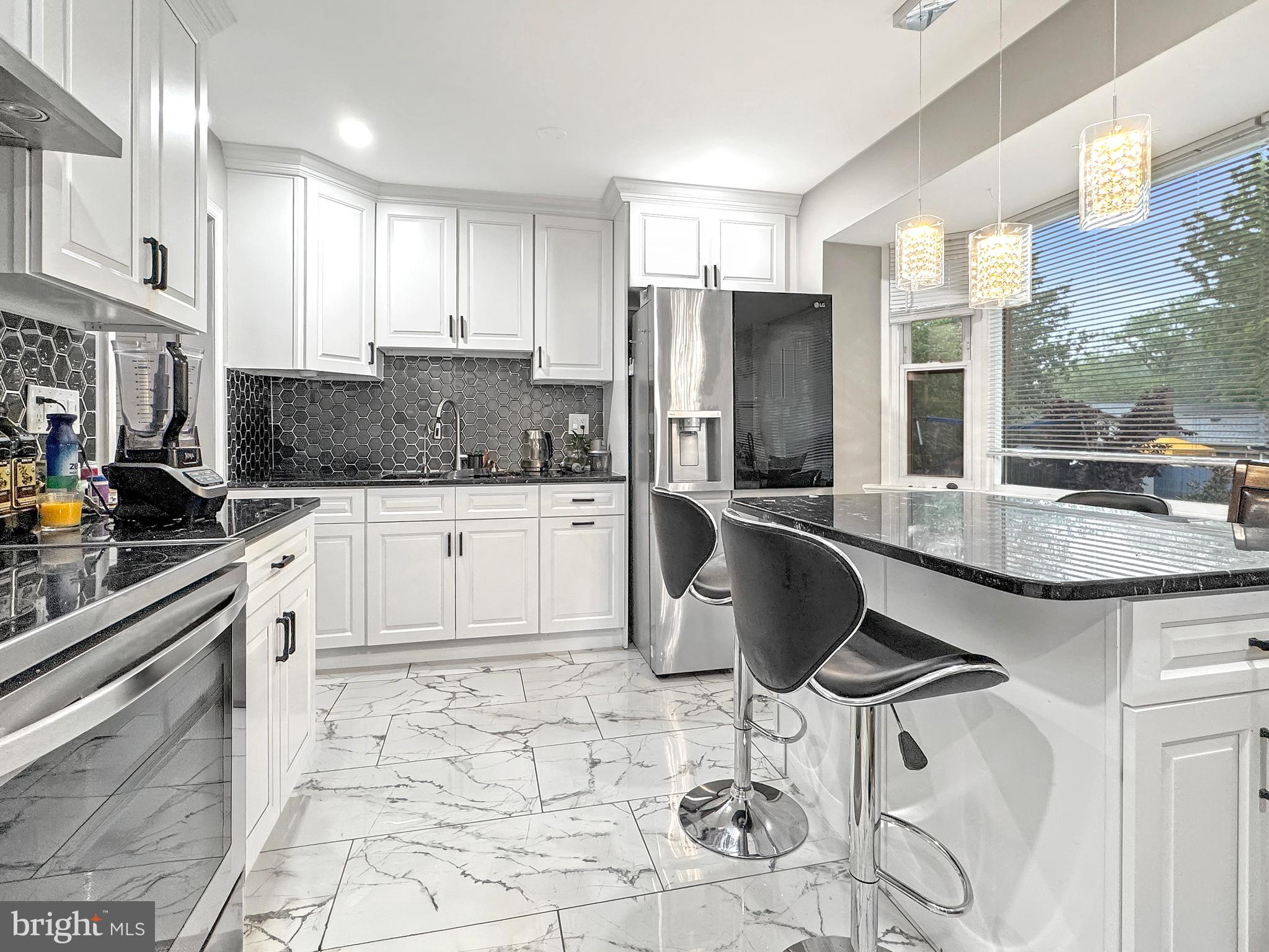 2408 Lillian Drive Silver Spring, MD 20902 - Photo 18 of 54 a kitchen with granite countertop a stove a sink and a refrigerator