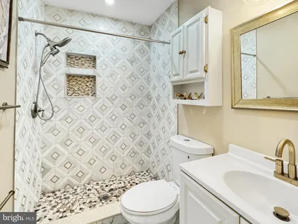 a bathroom with a sink a toilet and a mirror