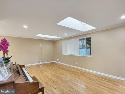 a room with wooden floor and window
