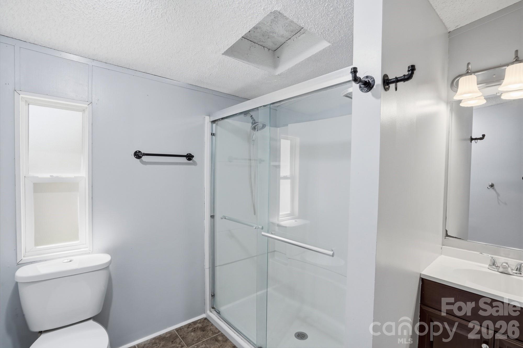 605 Ridgewood Court Mount Holly, NC 28120 - Photo 11 of 32 a bathroom with a shower toilet and sink