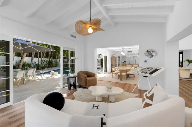 a living room with furniture and a chandelier