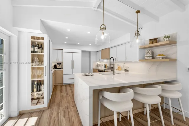 a kitchen with a sink cabinets and wooden floor