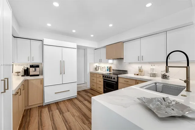 a dining room with furniture a chandelier and wooden floor