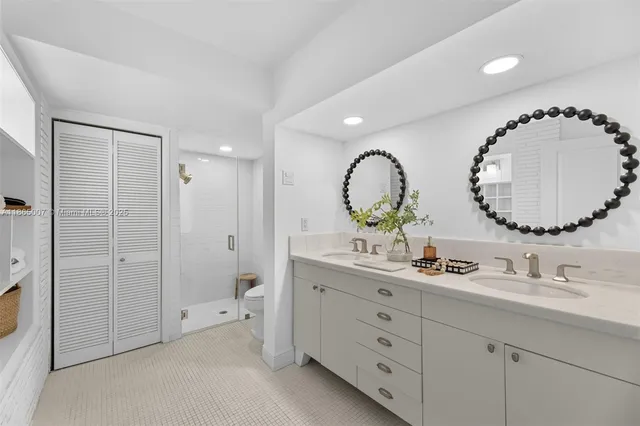 a view of a patio with table and chairs potted plants and floor to ceiling window