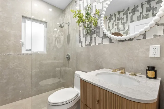 a view of a chair and tables in the patio and a glass door