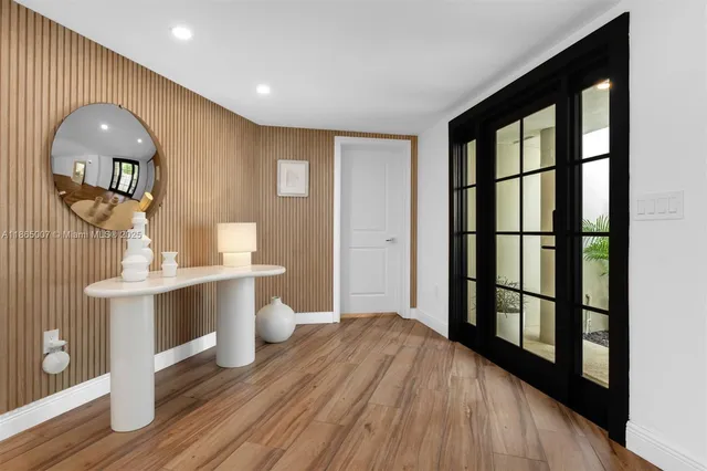 a dining room with furniture window and wooden floor