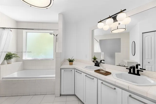 a view of swimming pool with a patio and a garden