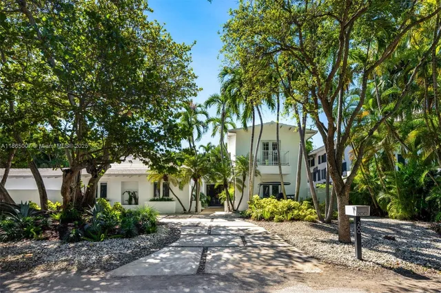 a backyard of a house with yard table and chairs