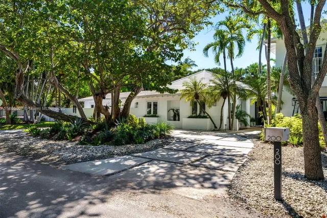 front view of a house with swimming pool and sitting area