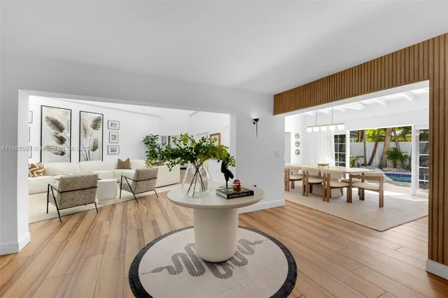 a view of a livingroom with furniture and a potted plant