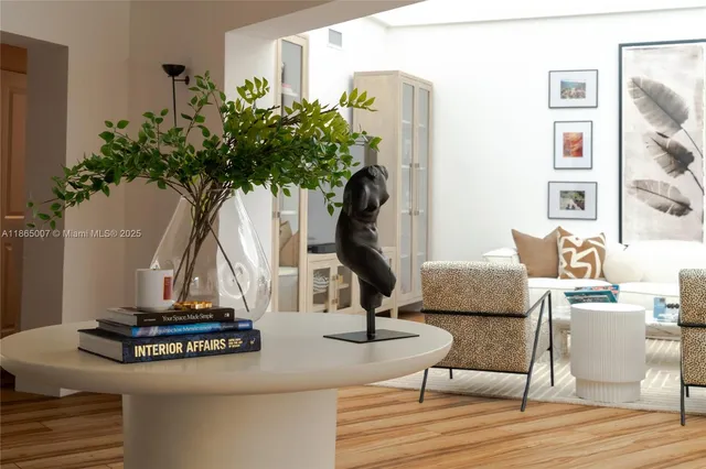 a living room with furniture a chandelier and a flat screen tv