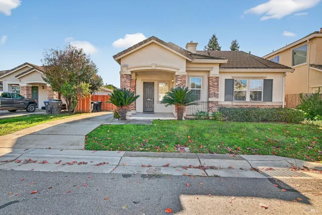 a front view of a house with a yard and a garage
