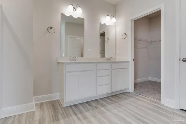 wooden floor with white cabinets