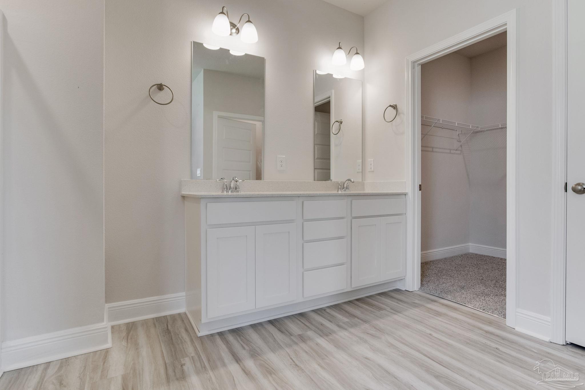 3423 Crossvine Road Cantonment, FL 32533 - Photo 17 of 35 wooden floor with white cabinets