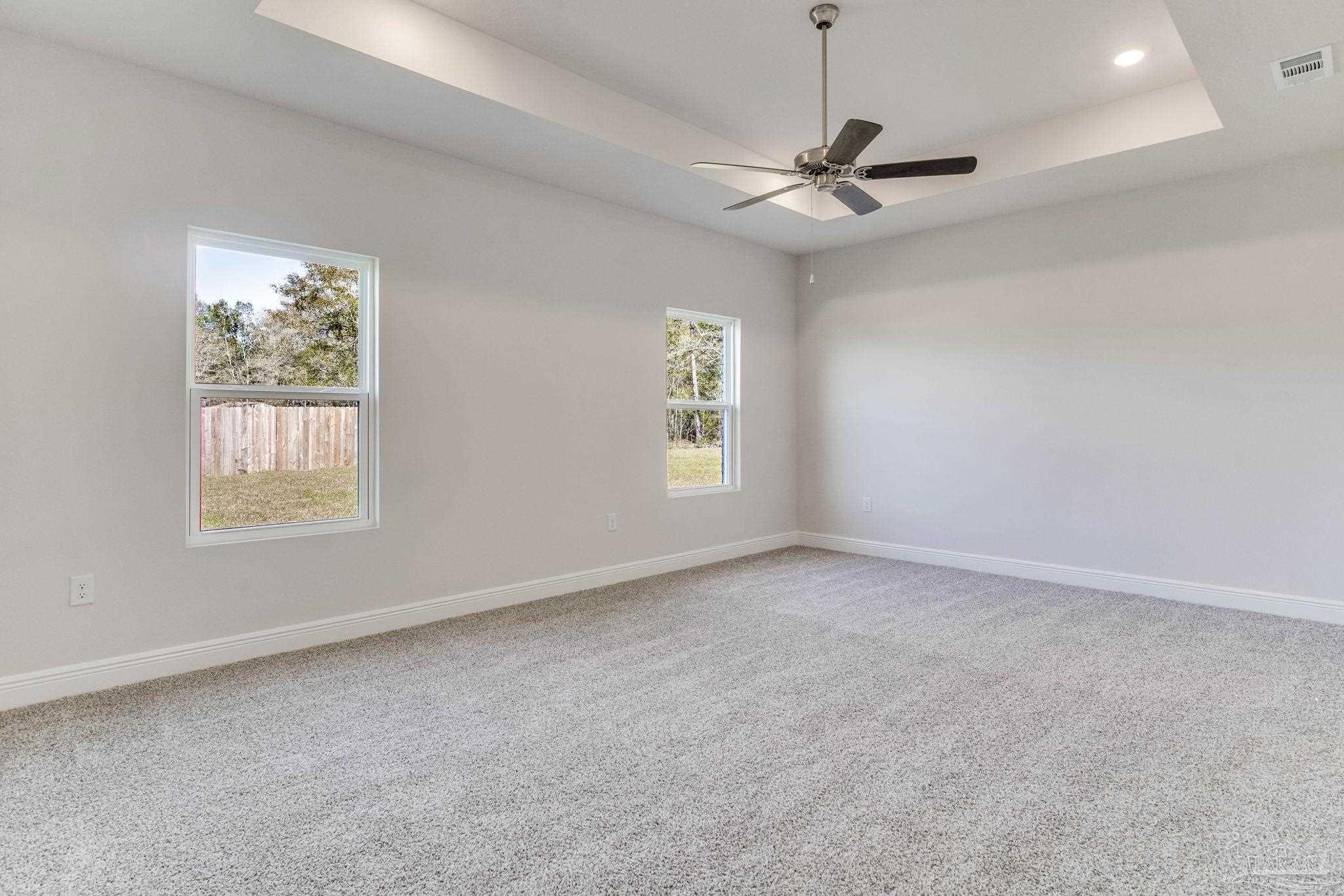 3423 Crossvine Road Cantonment, FL 32533 - Photo 18 of 35 an empty room with windows and fan