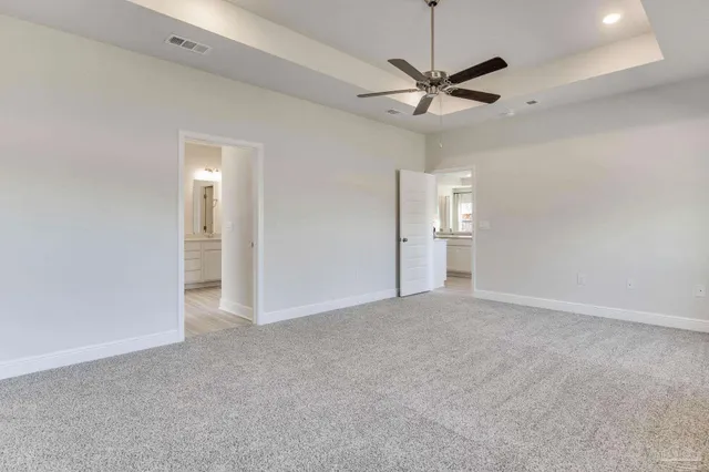 a view of an empty room with a ceiling fan and window
