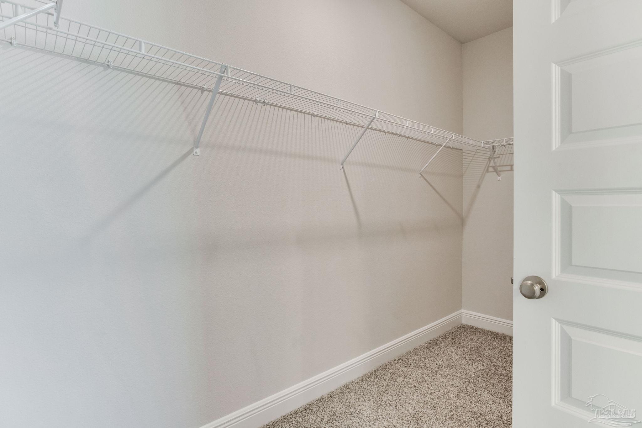 3423 Crossvine Road Cantonment, FL 32533 - Photo 21 of 35 a view of a room with racks on the wall