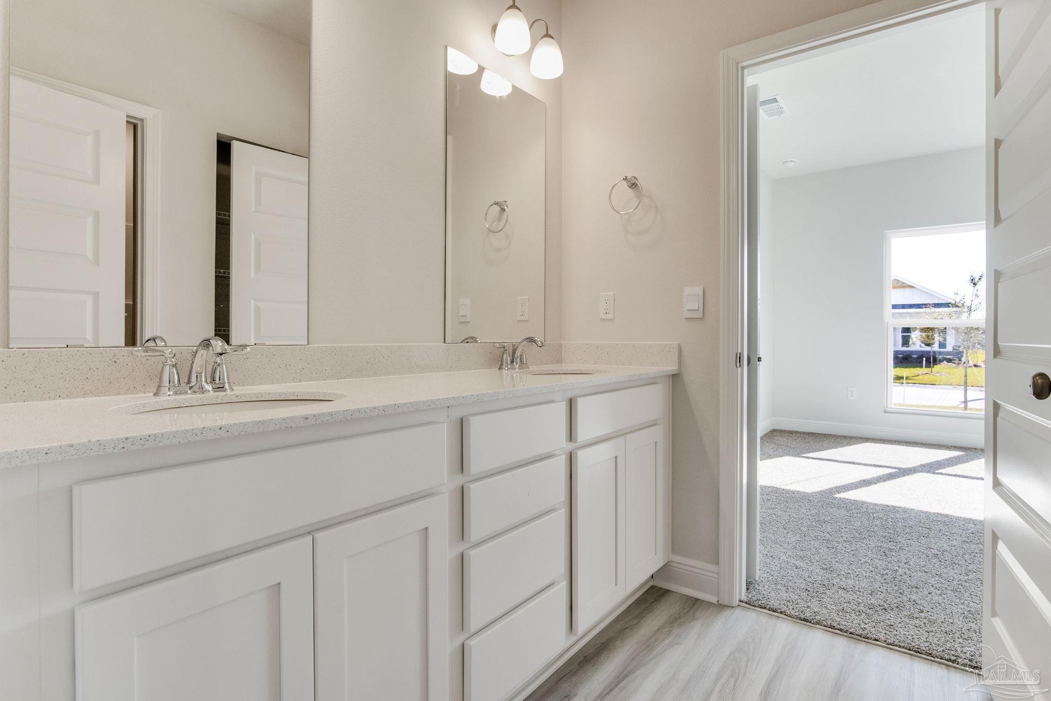 3423 Crossvine Road Cantonment, FL 32533 - Photo 26 of 35 a bathroom with a sink and a mirror