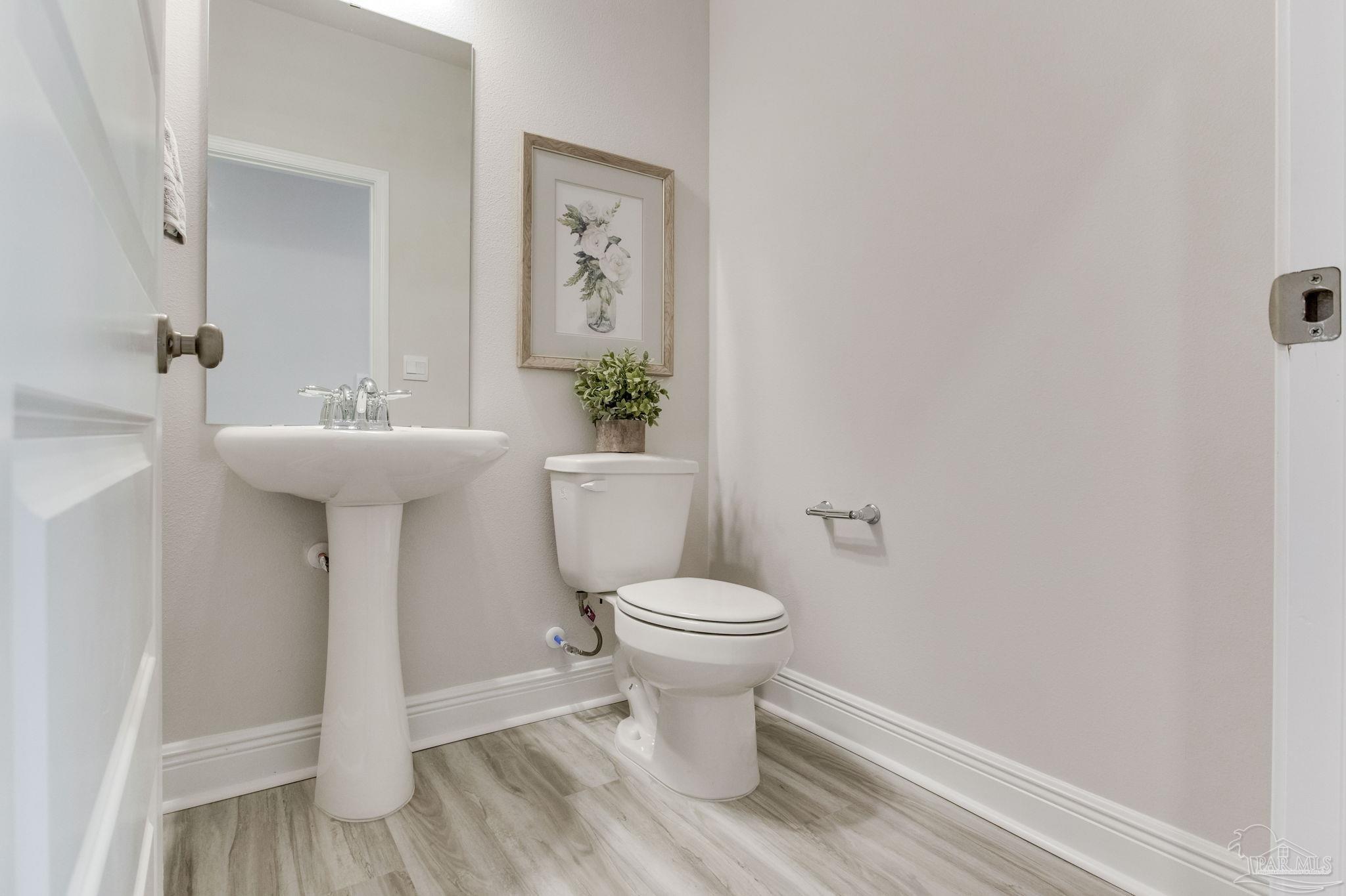 3423 Crossvine Road Cantonment, FL 32533 - Photo 29 of 35 a bathroom with a sink toilet and a mirror