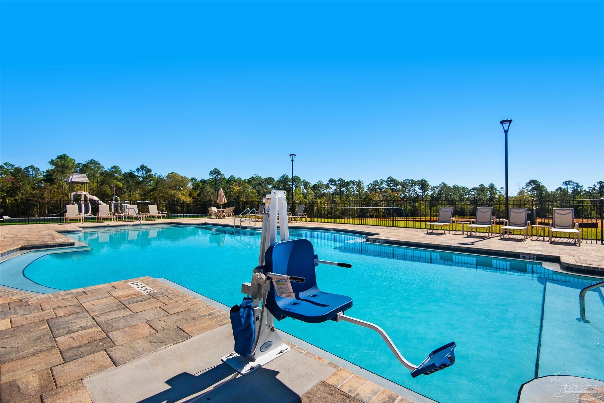 3423 Crossvine Road Cantonment, FL 32533 - Photo 32 of 35 a view of a swimming pool and lounge chairs