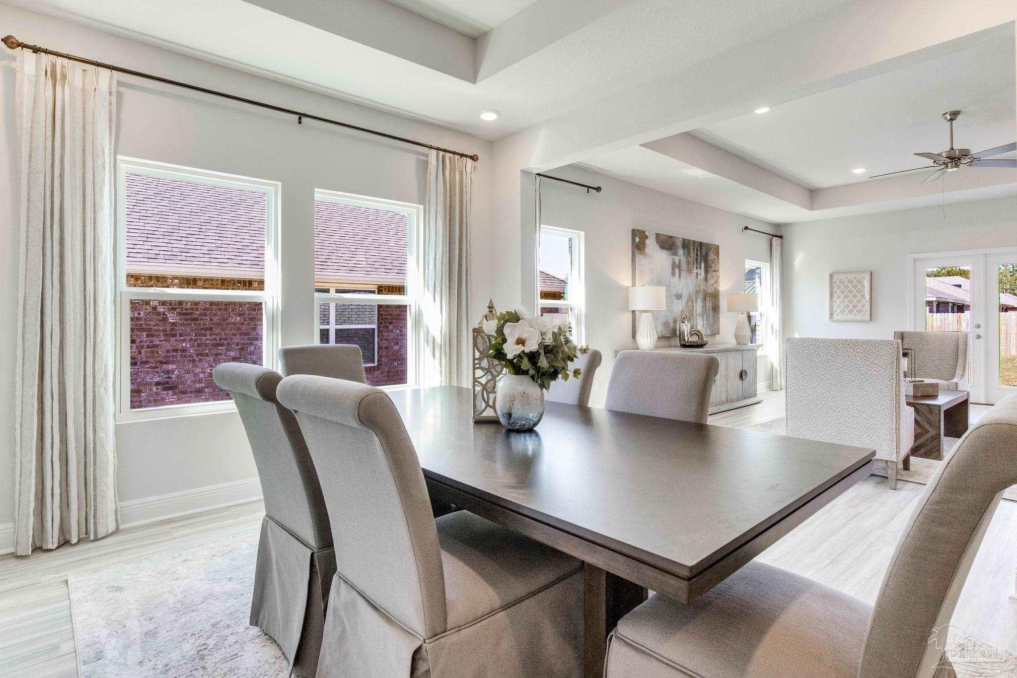 3423 Crossvine Road Cantonment, FL 32533 - Photo 10 of 35 a view of a dining room with furniture and wooden floor