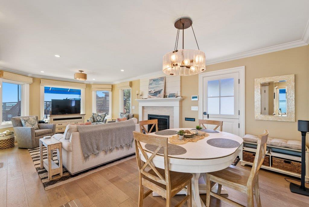 1500 Wharf Road, Unit 22 Capitola, CA 95010 - Photo 14 of 48 a dining room with furniture a chandelier and wooden floor