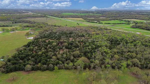 a view of a field with an ocean